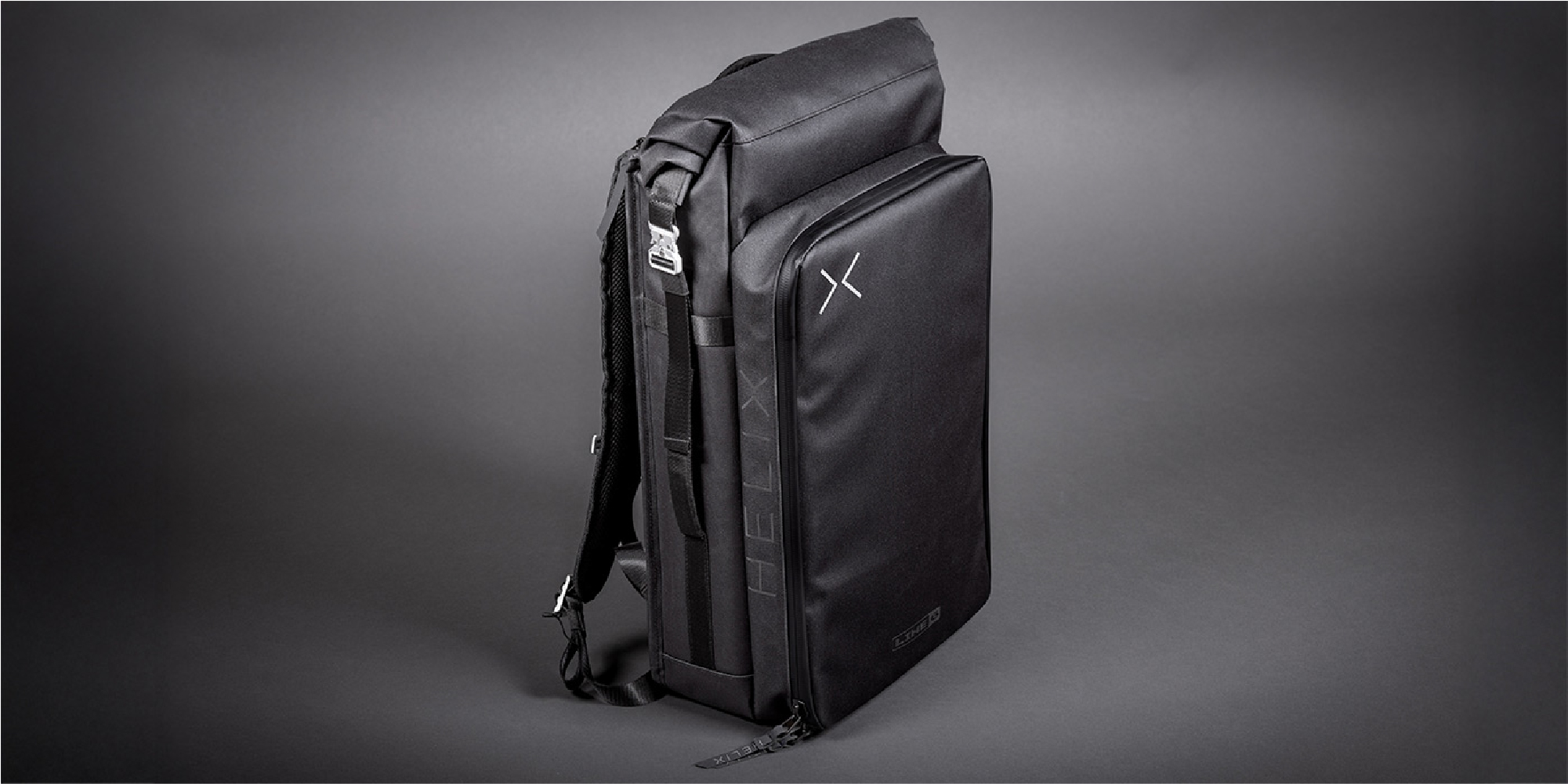 Line 6 HELIX STADIUM BACKPACK Black modular backpack standing upright on a dark gray studio background, with multiple zippers and straps visible.