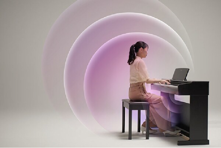 yamaha ydp-146r yamaha ydp-146wh 12 - mustore woman playing a keyboard with a laptop on top, seated at a bench amid large pink-purple concentric rings in a studio setup. - mustore