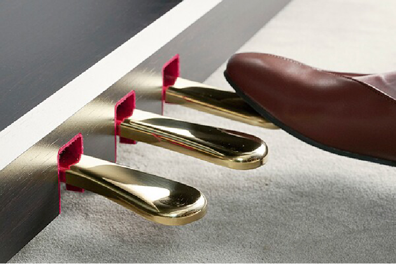 yamaha ydp-146r yamaha ydp-146wh 7 - mustore close-up of three brass piano pedals under a dark wooden piano, with a brown leather shoe nearby on the right side. - mustore