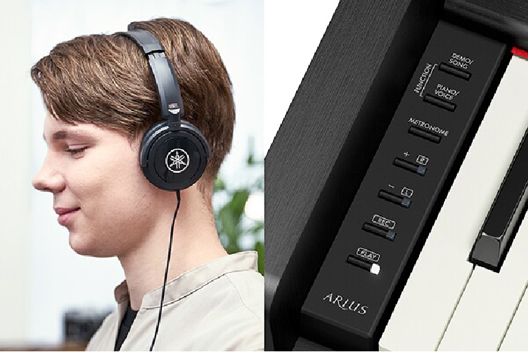 Person wearing over-ear headphones listening to music, shown beside a close-up of a piano keyboard and its control panel labeled ARUS.