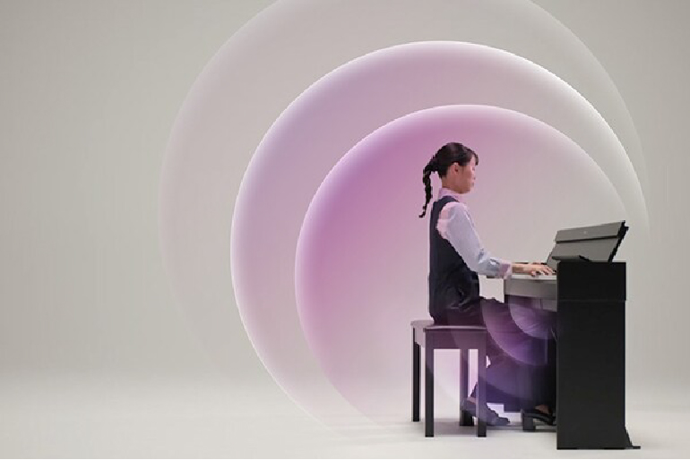 Young girl in a vest and white shirt sitting at a black piano, playing, with pastel circular light rings in the background.
