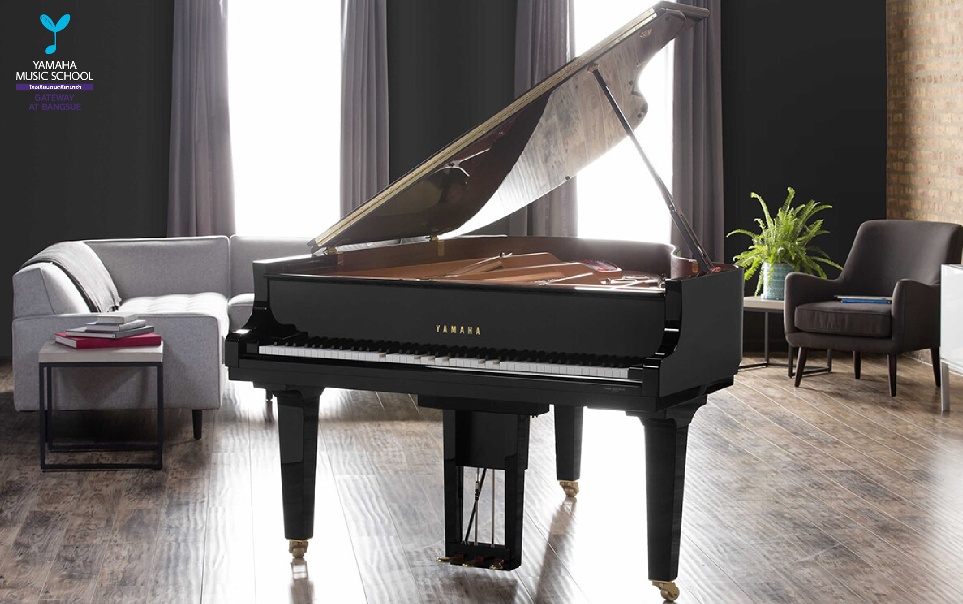 Black Yamaha grand piano centered in a modern living room with a gray sofa, chair, plant, and wooden floor backdrop.
