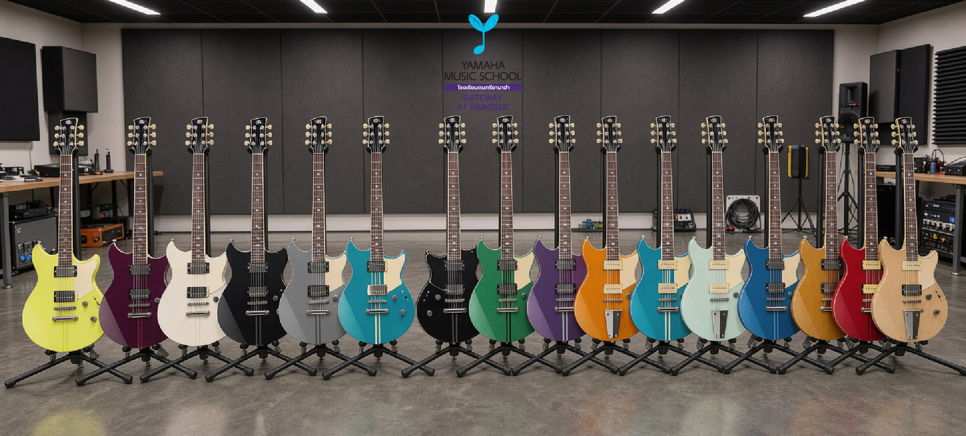 Row of colorful electric guitars on stands in a music studio with soundproof panels and a Yamaha Music School logo on the back wall